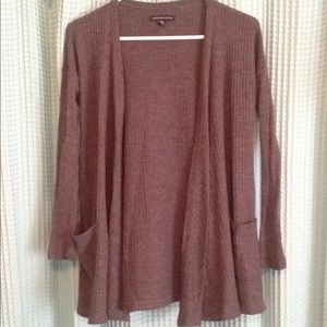 Gray sweater. Pockets on front. Think material